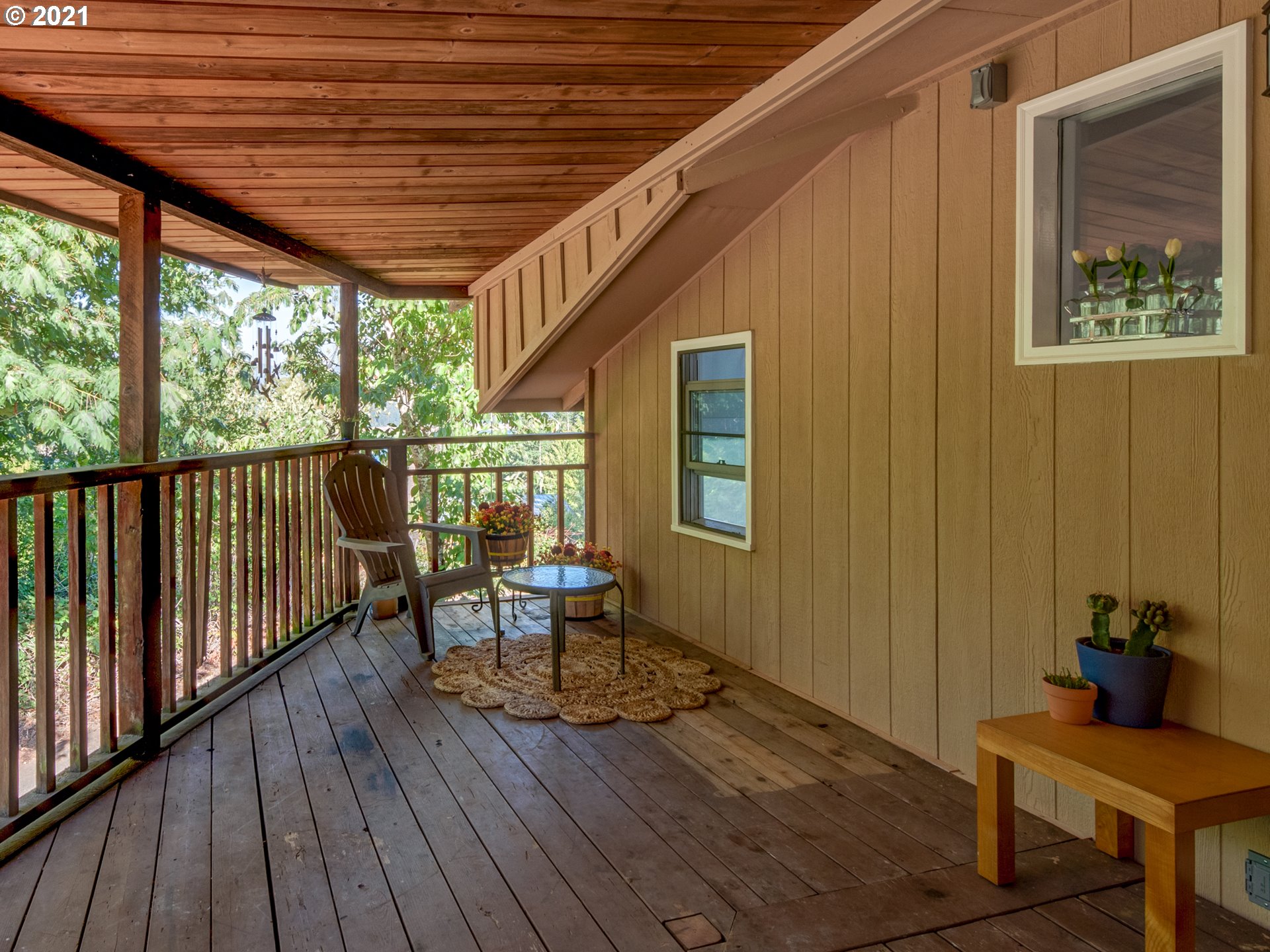 82039 Chickaree Road Lowell, OR 97452 - Photo 24 of 30 a balcony with wooden floor and furniture