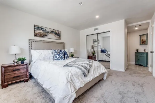 a bedroom with a bed and a painting