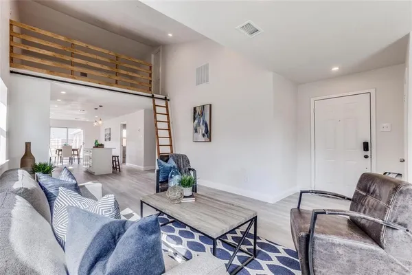 a living room with furniture and wooden floor