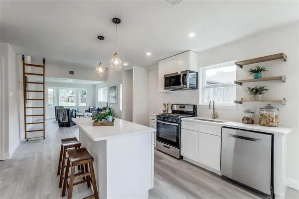 a kitchen with a sink stove and cabinets