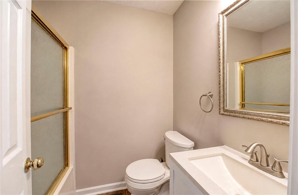 218 Gilreath Road Southeast Cartersville, GA 30121 - Photo 13 of 27 a white toilet sitting next to a bathroom sink