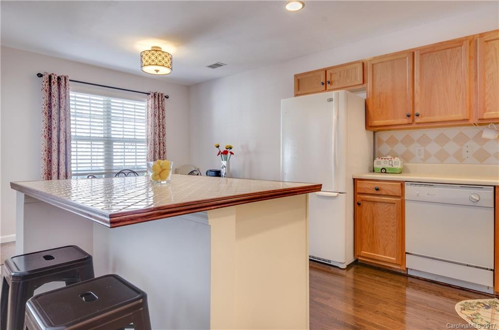 11642 Rabbit Ridge Road, Unit 2073 Charlotte, NC 28270 - Photo 8 of 24 a kitchen with stainless steel appliances granite countertop a refrigerator and a stove top oven