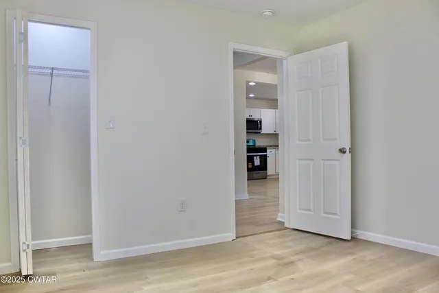 an empty room with wooden floor