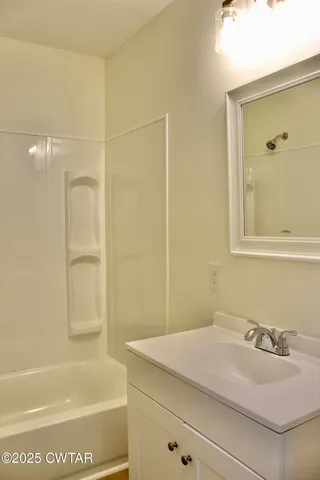 a bathroom with a bathtub and a sink