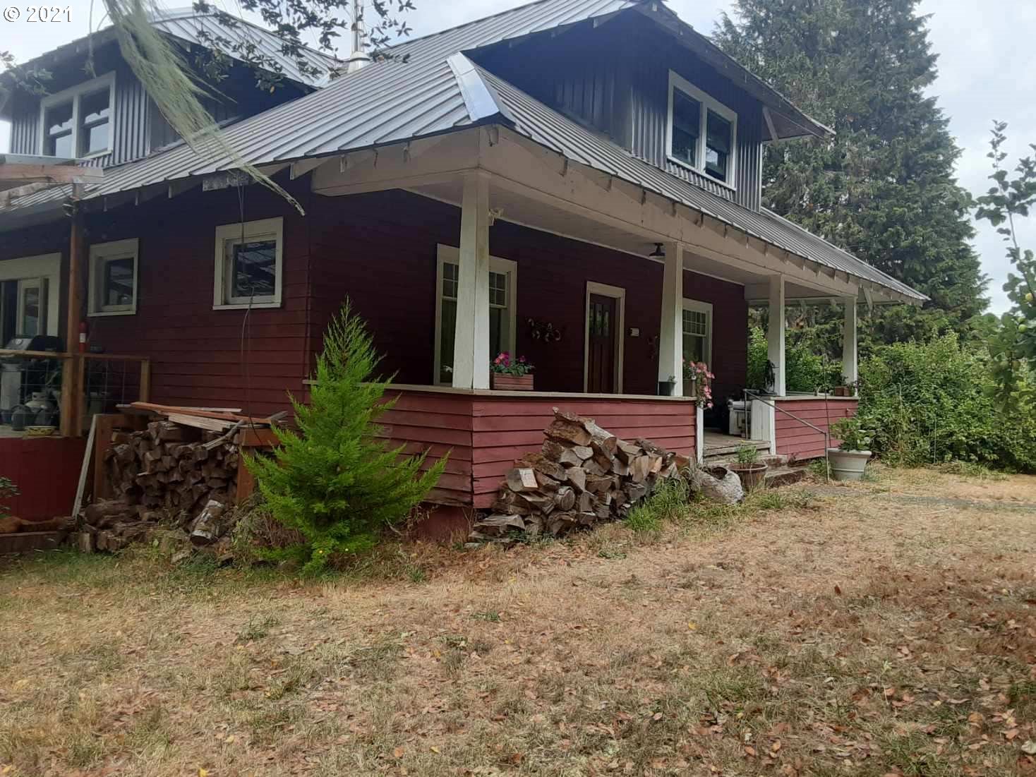 438 Soup Creek Road Reedsport, OR 97467 - Photo 2 of 30 a view of a house with a small yard and large tree