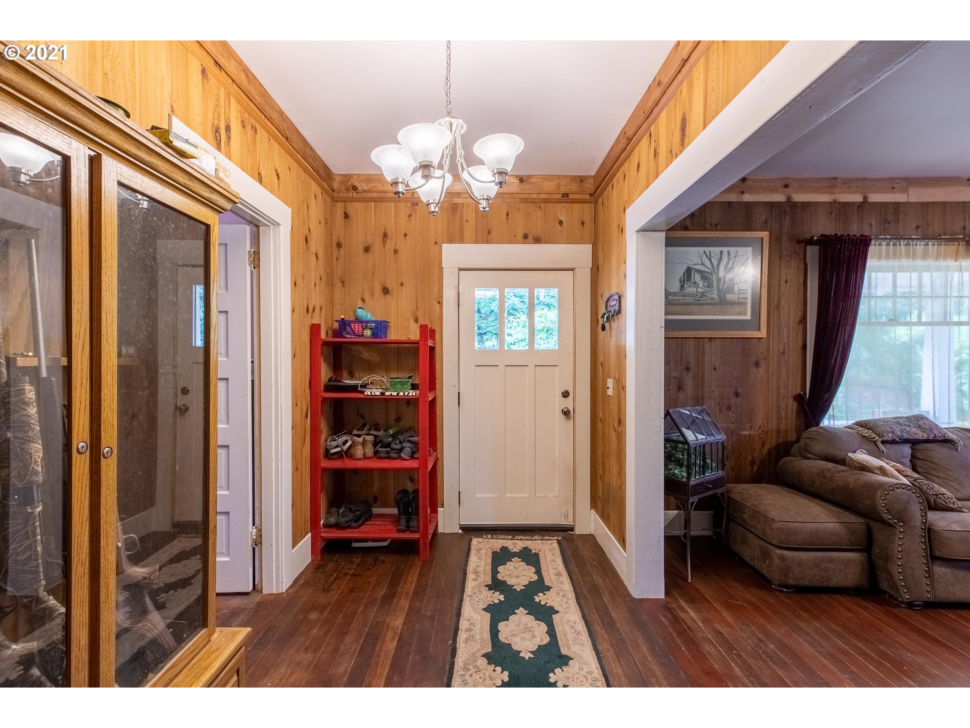 438 Soup Creek Road Reedsport, OR 97467 - Photo 15 of 30 a living room with furniture and a chandelier