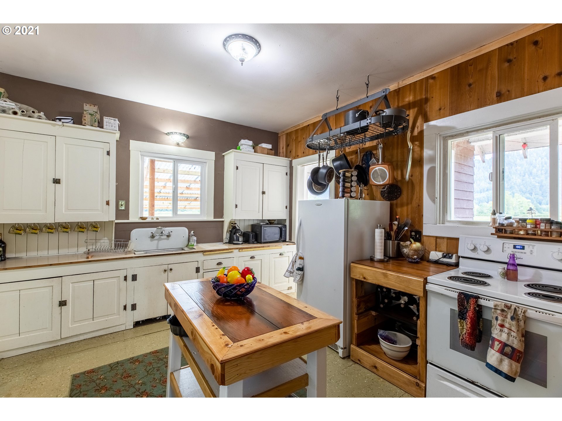 438 Soup Creek Road Reedsport, OR 97467 - Photo 17 of 30 a kitchen with stainless steel appliances kitchen island granite countertop a refrigerator and a stove