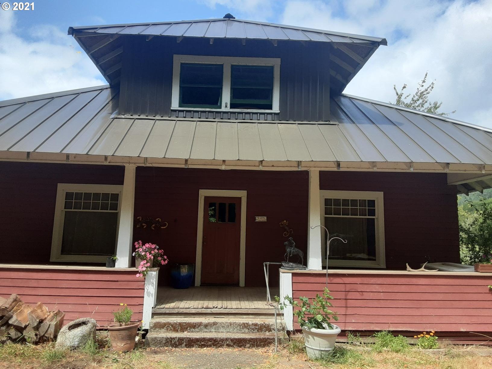 438 Soup Creek Road Reedsport, OR 97467 - Photo 3 of 30 a brick house with a large windows