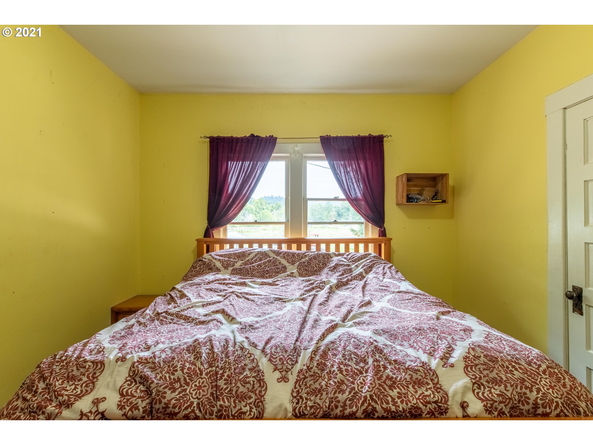 438 Soup Creek Road Reedsport, OR 97467 - Photo 22 of 30 a bedroom with a bed