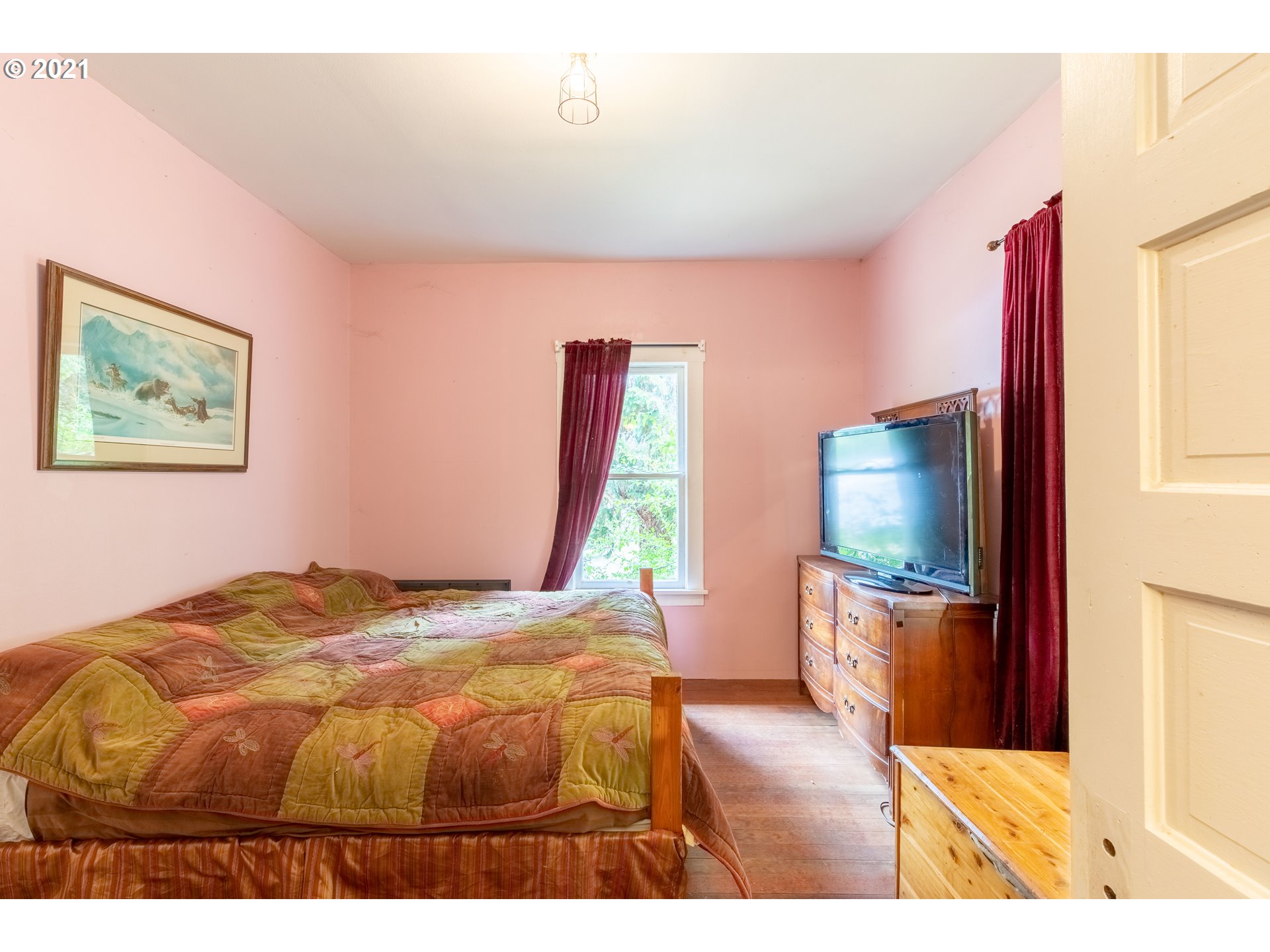 438 Soup Creek Road Reedsport, OR 97467 - Photo 24 of 30 a bedroom with a bed and a flat screen tv