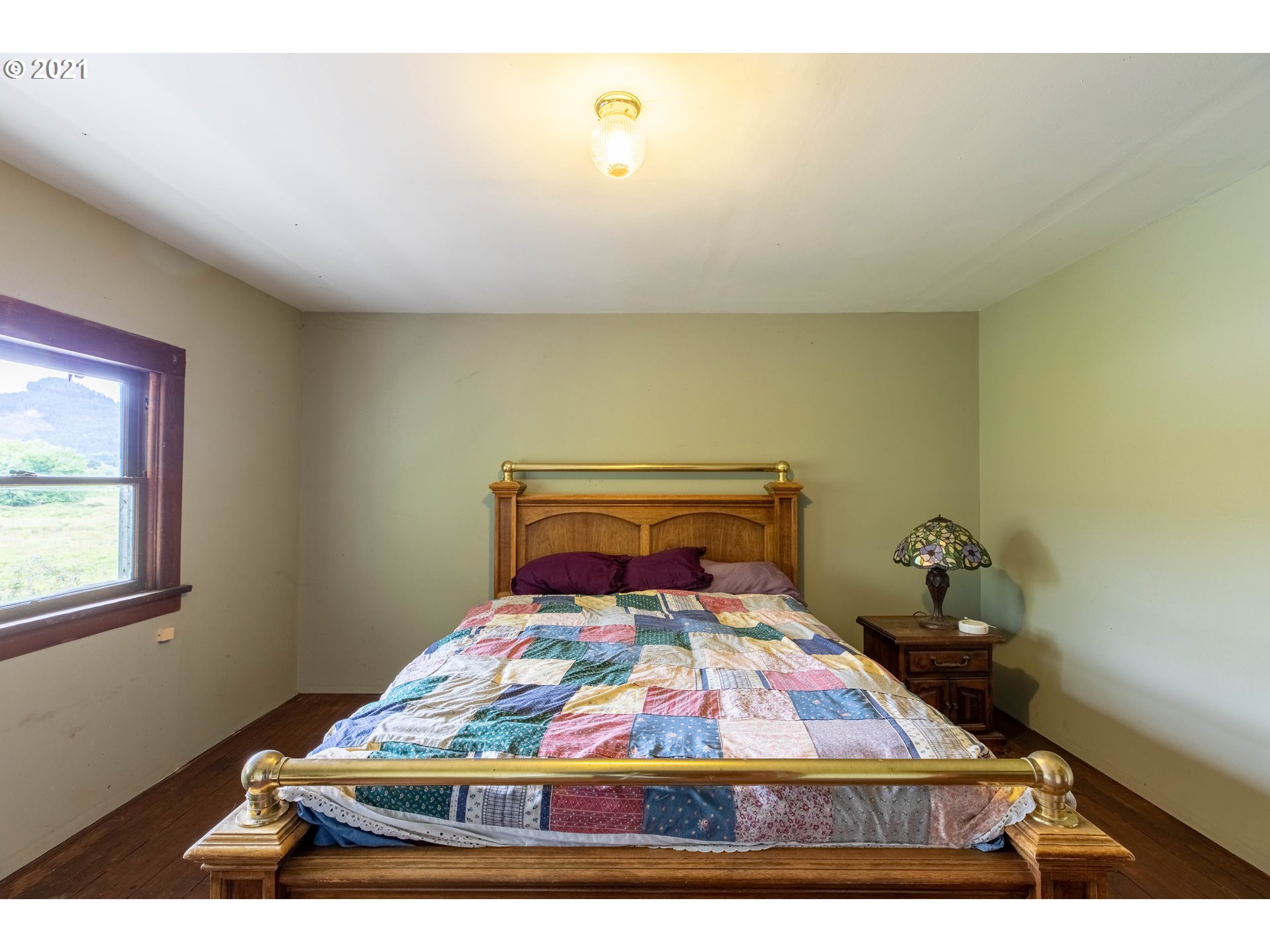 438 Soup Creek Road Reedsport, OR 97467 - Photo 30 of 30 a bedroom with a bed and window