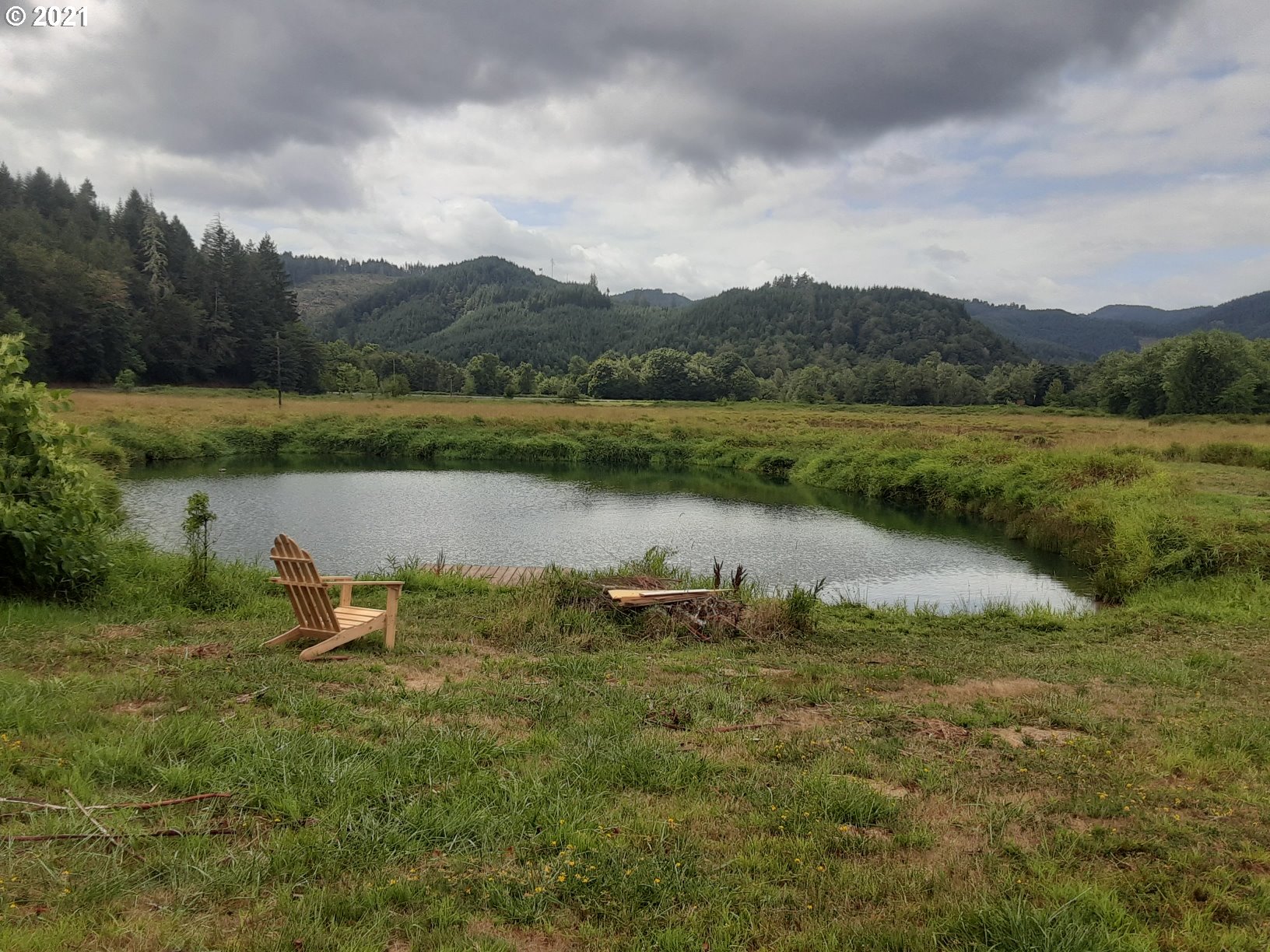 438 Soup Creek Road Reedsport, OR 97467 - Photo 7 of 30 a view of a lake in between two of houses