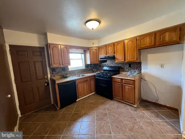 a kitchen with a sink stove and refrigerator