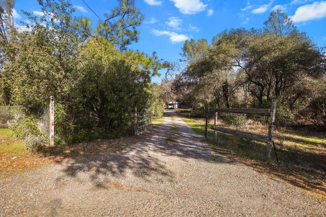 a view of a house with a backyard and porch