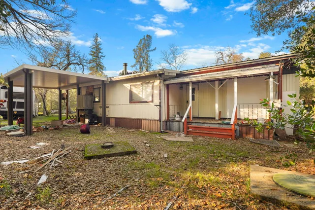 a view of a white house with a yard