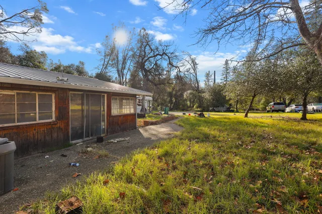 a house view with swimming pool in front of it