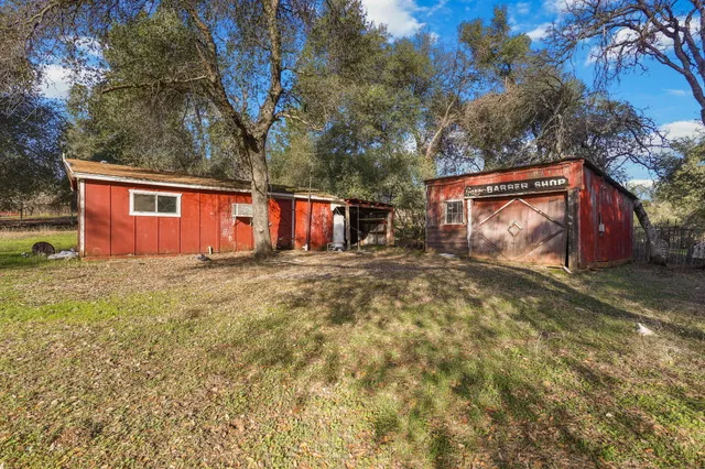 a view of a yard with wooden fence