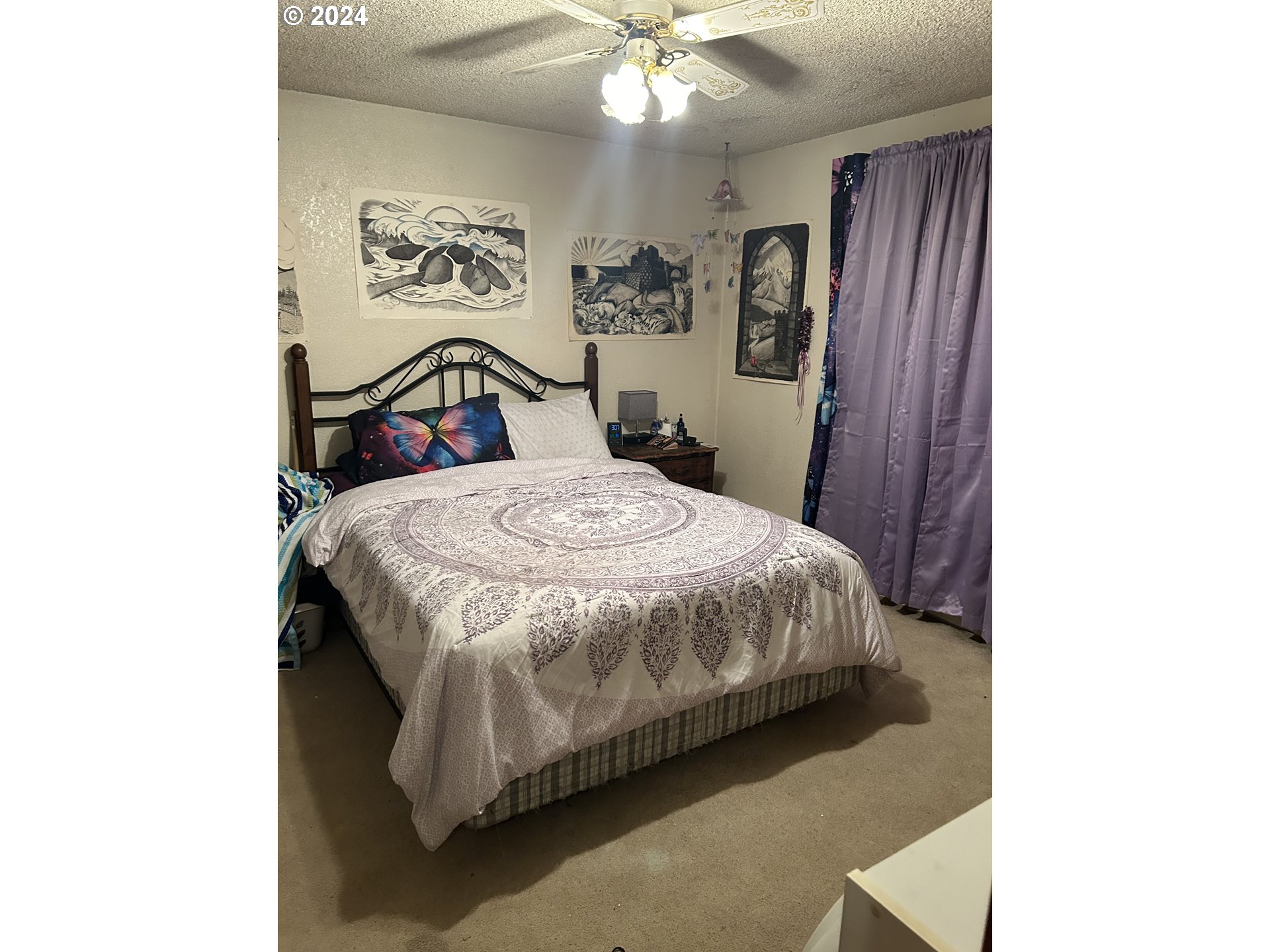 4807 Daisy Street Springfield, OR 97478 - Photo 8 of 12 a bedroom with a bed and a chandelier