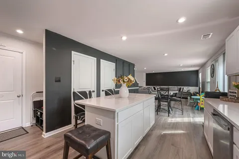 a very nice looking dining room with a large window and stainless steel appliances