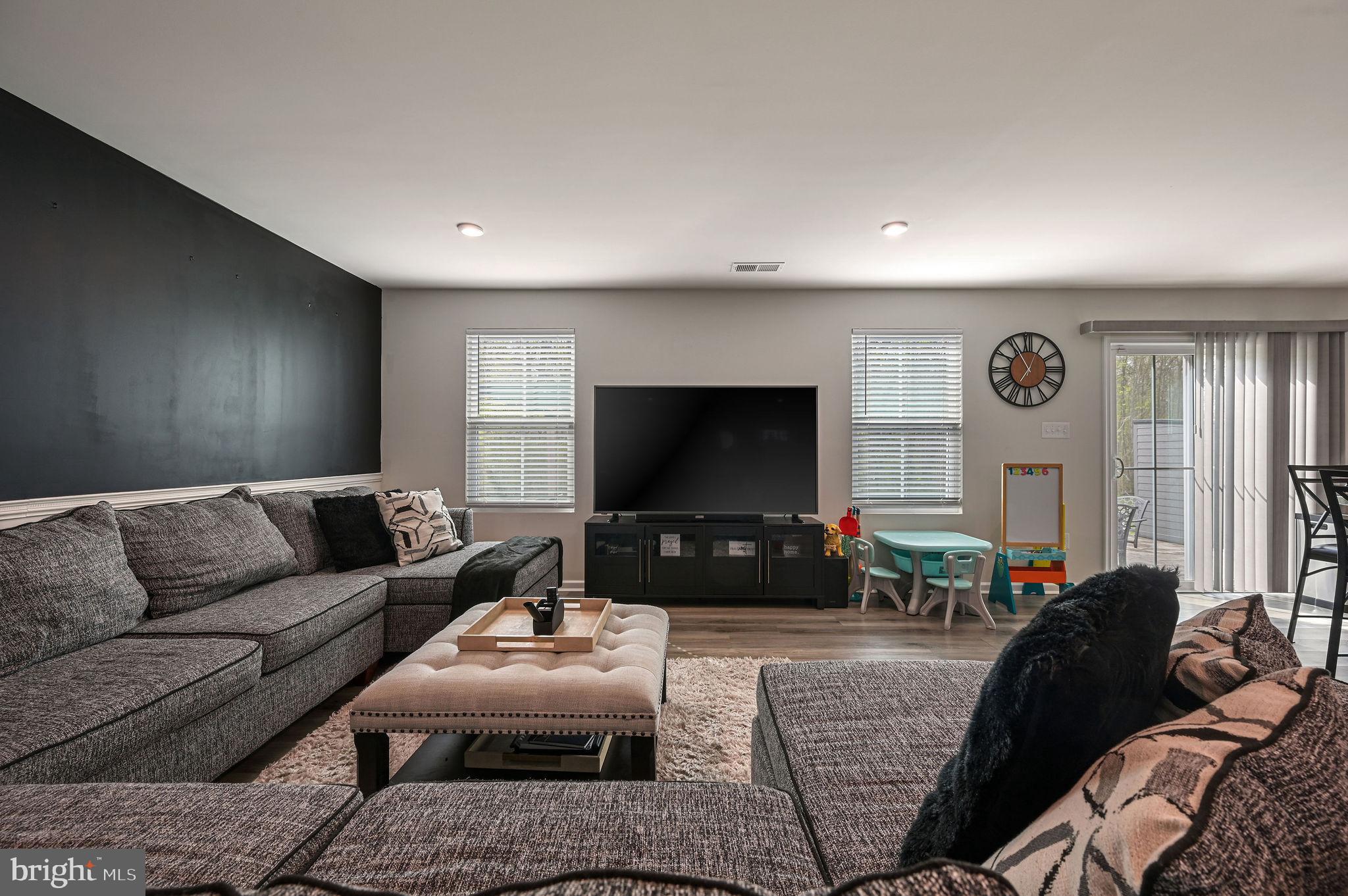 343 Sedimentary Rock Road Dover, DE 19904 - Photo 15 of 27 a living room with furniture and a flat screen tv