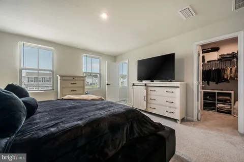 a bedroom with a bed and flat screen tv