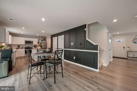 a kitchen with a table and chairs in it