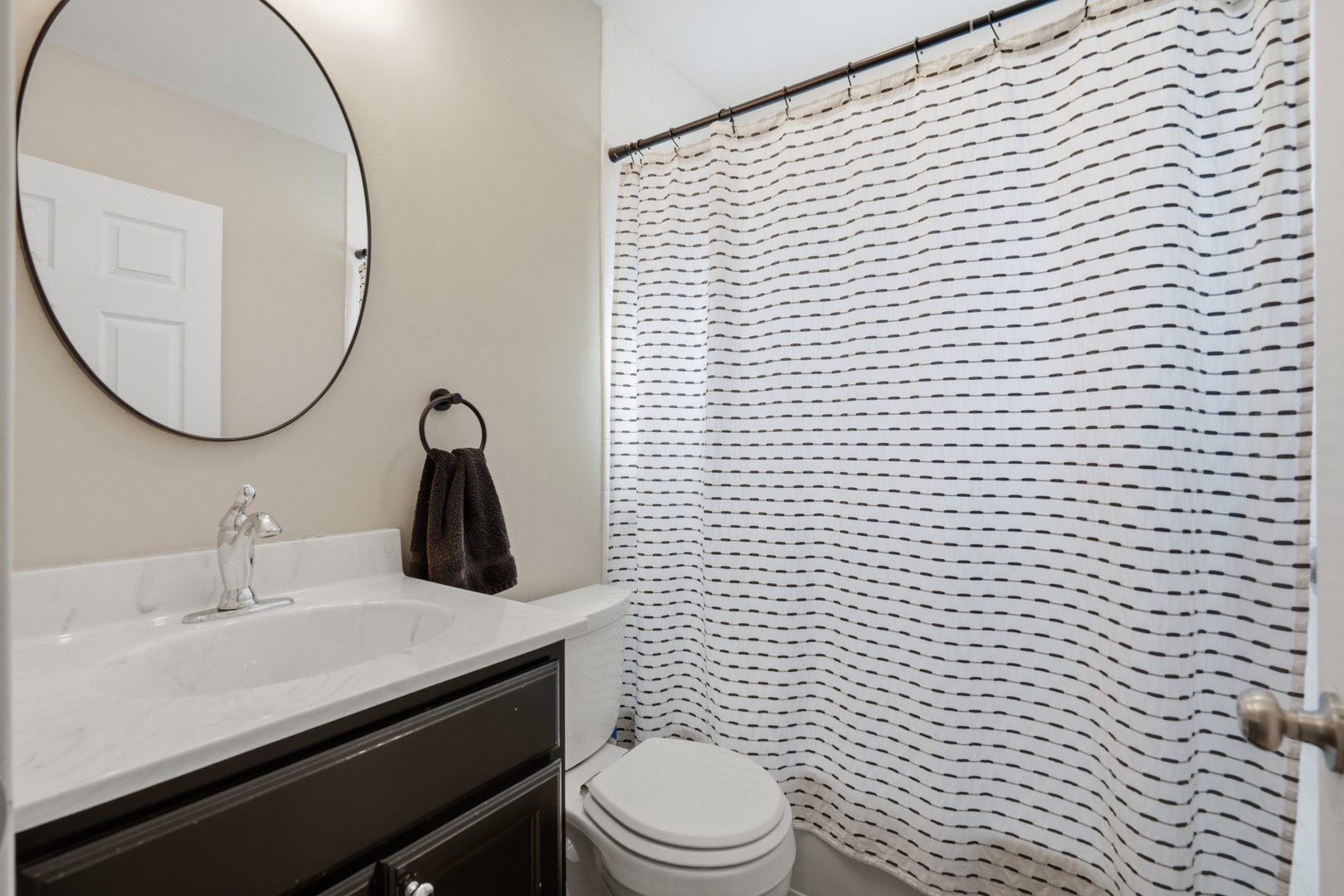 3443 3rd Street B East Moline, IL 61244 - Photo 14 of 23 a bathroom with a toilet a sink a mirror and shower