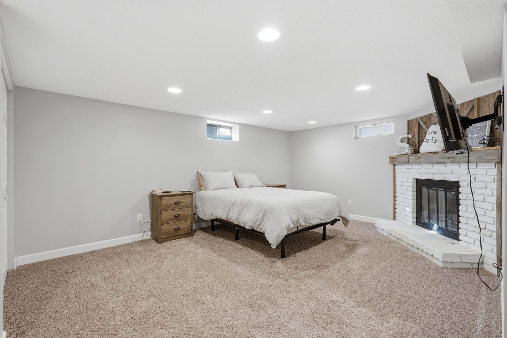 3443 3rd Street B East Moline, IL 61244 - Photo 16 of 23 a spacious bedroom with a bed and a fireplace