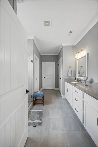 a large en suite bathroom with a granite countertop tub double and sink