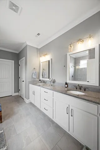 a spacious bathroom with a granite countertop sink mirror and
