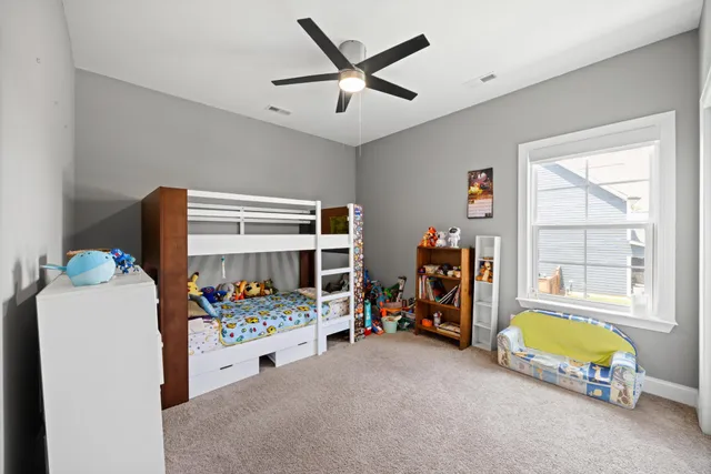 a bed room with a bed and a chair