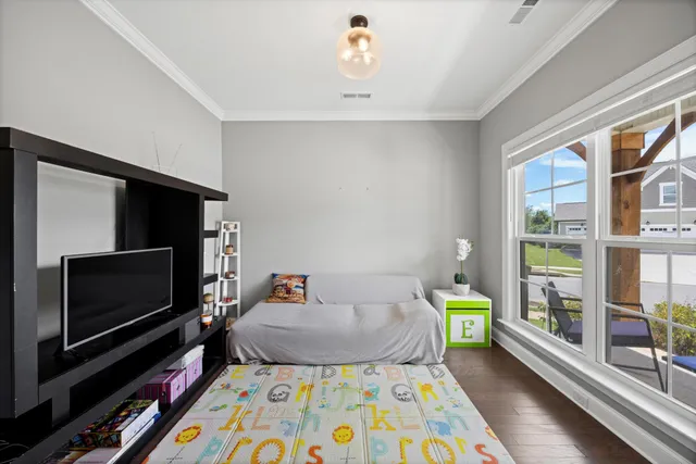 a bed room with furniture and a flat screen tv