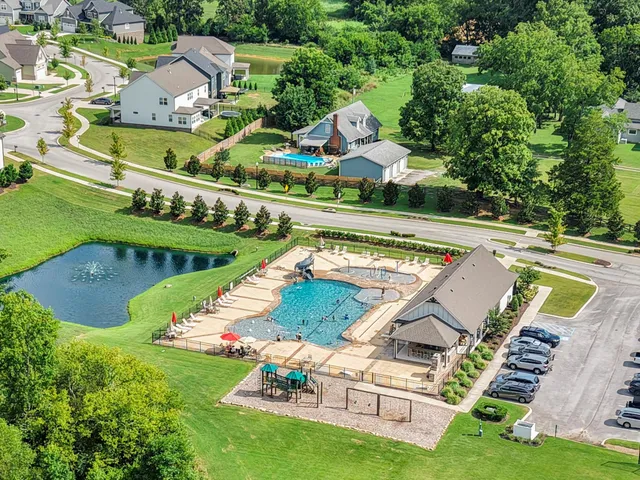 an aerial view of a house with a garden and swimming pool