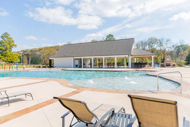 a view of house with yard and sitting area