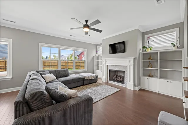 a living room with furniture fireplace and flat screen tv