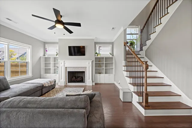 a living room with furniture a fireplace and a flat screen tv