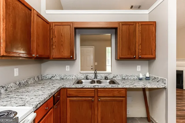 a kitchen with stainless steel appliances granite countertop wooden cabinets a sink and dishwasher