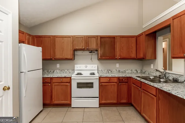 a kitchen with a sink stove and refrigerator