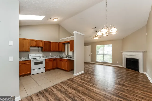 a large kitchen with a stove top oven and refrigerator