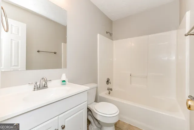 a bathroom with a sink a toilet and a bathtub