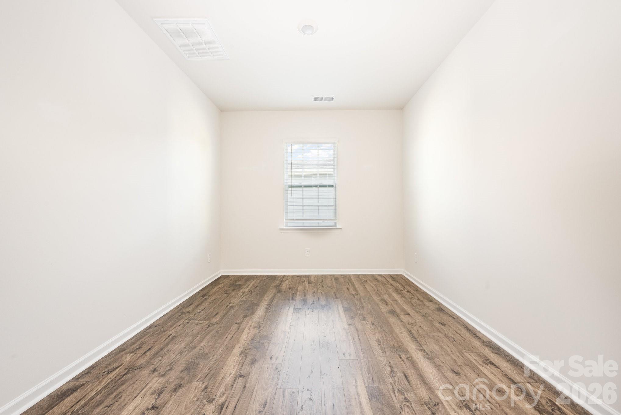 2116 Vanderlyn Street Monroe, NC 28112 - Photo 11 of 20 a view of a room with wooden floor and windows