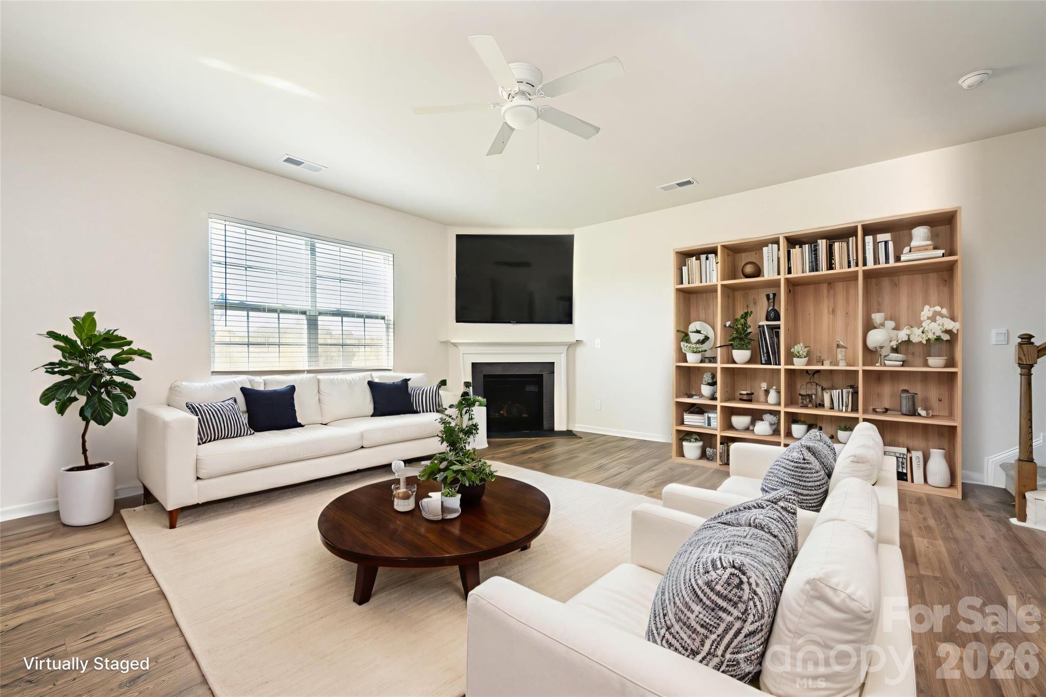 2116 Vanderlyn Street Monroe, NC 28112 - Photo 3 of 20 a living room with furniture a fireplace and a flat screen tv
