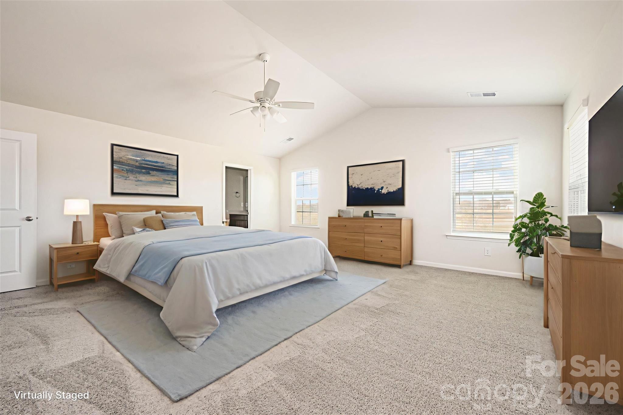 2116 Vanderlyn Street Monroe, NC 28112 - Photo 4 of 20 a spacious bedroom with a bed a couch and potted plant on the dresser