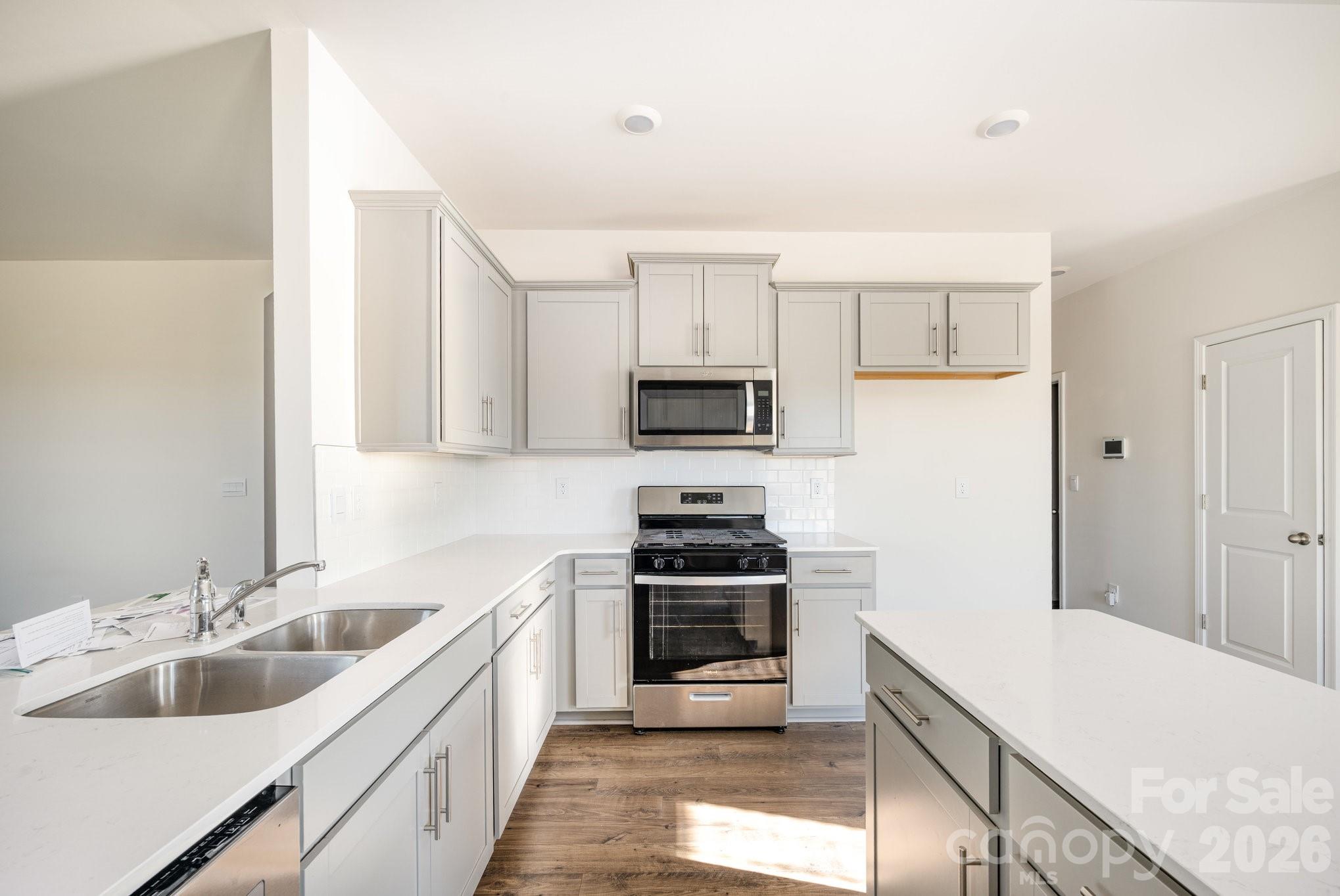 2116 Vanderlyn Street Monroe, NC 28112 - Photo 5 of 20 a kitchen with a sink cabinets and stainless steel appliances
