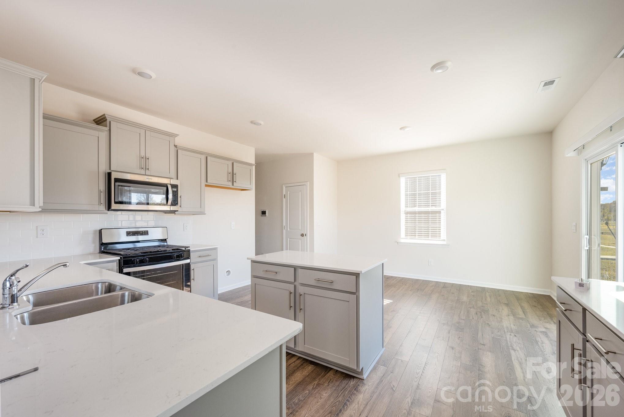2116 Vanderlyn Street Monroe, NC 28112 - Photo 6 of 20 a kitchen with a refrigerator stove and sink