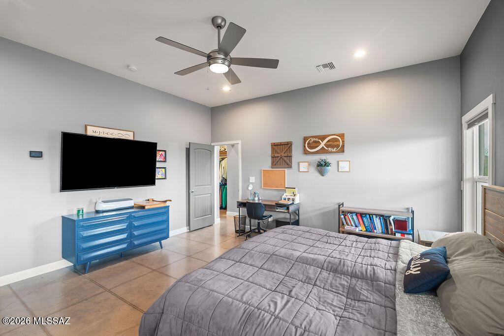 16276 East Empire View Road Vail, AZ 85641 - Photo 36 of 51 a bedroom with a large bed and a flat screen tv