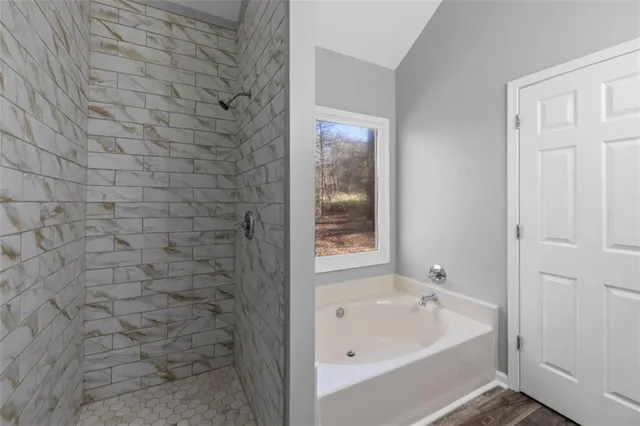 a bathroom with a bathtub and shower