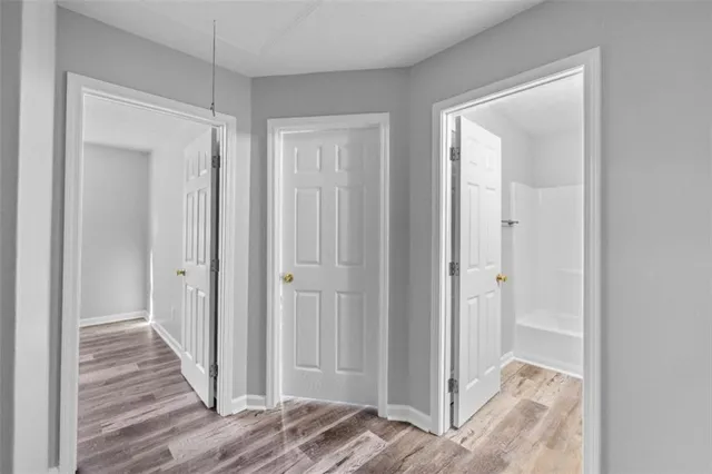 a view of a hallway with wooden floor