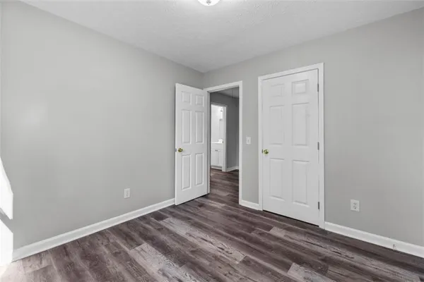 a view of an empty room and wooden floor