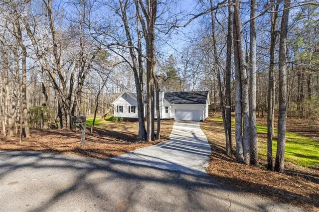 a view of a yard with wooden fence